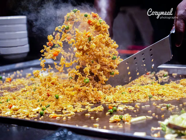 Hibachi Fried Rice - Fresh ingredients being cooked with theatrical flair